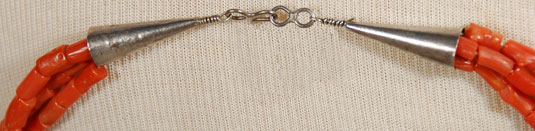 capped at the ends with silver cones and handmade silver clasp