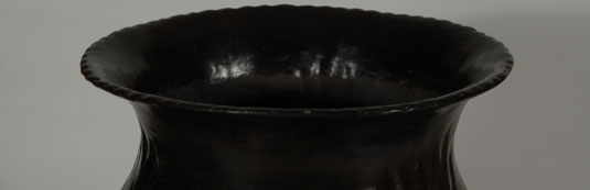 The graceful concave neck rising upward to a fluted rolled-out rim is another sign of her work.  The fluting at the rim has been said to represent rain, an appropriate symbol for a water jar.  