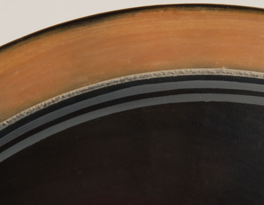 This black bowl with a sienna rim and a pair of matte framing lines is a most elegant piece of art.  The contrast between the highly-polished black center section, softened by a sienna edge, was an ingenious idea of his.  The inner edge of the sienna is framed by a sgraffito framing line placed adjacent to the pair of matte black framing lines at the edge of the black.