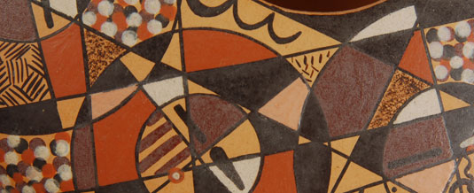 Close up view: overlapping circles in which there are faces or masks.  Overlaid on these circles are one-inch-wide strips which add another layer to the design, resulting in a three-dimensional appearance.  The whole design is subdivided into smaller triangles, squares, rectangles and circles. 
