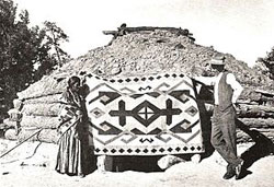 J.B. Moore with a weaver and rug at the Crystal Trading Post, from the 1911 catalog - Image Source: Wikipedia