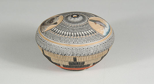 Side view: The upper half of the jar is completely covered in designs of this intricacy.  The bottom half of the design is the artist’s traditional application of the Navajo ceremonial basket design executed in dimensional structure, not just painted on the surface. 