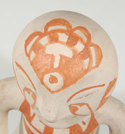 Close up view of the top of the head design of this Tesuque Rain God figurine.