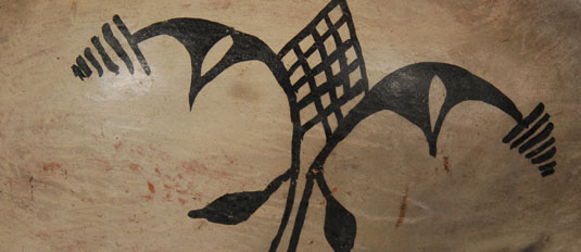 Designs are typical Cochiti designs of rain clouds, lightning, rain, and double bird elements.  Application of the four designs was well done with dark black vegetal paint.  