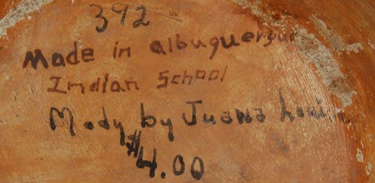 This Acoma jar has a notation on the underside Made in Albuquerque Indian School, a notation which was fired into the jar at the time it was made. In addition, written in ink after firing, is Made by Juana Louis $4.00, with the number 372.  This would suggest a date of 1937 when the jar was made and that date coincides with the date listed in Schaaf of her being an active potter from 1937 onward.  