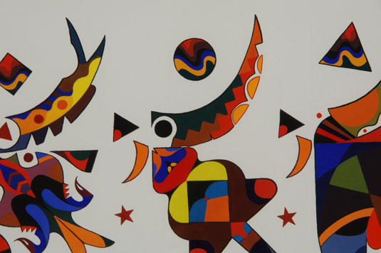 Close up view - Dancers of the Wind, a moving field of color. The artist has created three abstract dancers, possibly representing Eagle Dancers, each one uniquely rendered with a pleasing combination of shapes, colors and movement. 