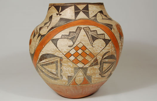 This Acoma olla is a good example of such.  When the black curved elements above the orange checkerboard design are examined closely, one sees the curved beak of the bird and the crown of the bird represented by the black triangle and fine-line stepped elements.  