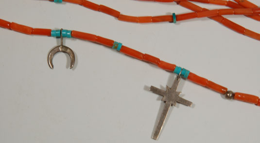 There are five sterling silver crosses and two crescent shaped pendants on the necklace.  