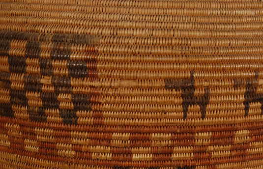 Horizontal bands and squares are decorated with checkerboard squares and some with small dots.  The design was executed in red and black.  There are small animals that may be wolves or dogs as decoration.
