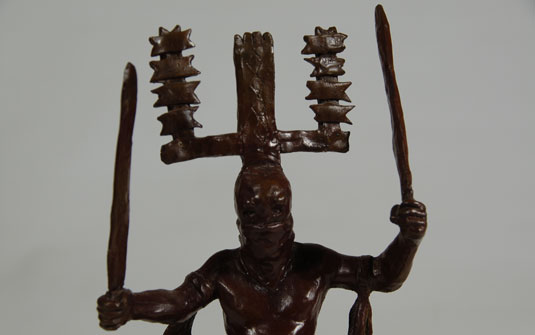 Close up view: This bronze sculpture represents the Apache Gaan Dancer, popularly called the Crown Dancer because of the large head piece worn by the dancers