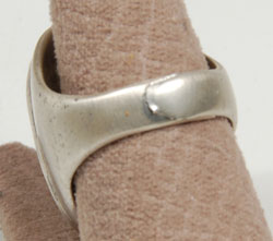 The silver shank on the ring has an overlap on the back which permits the ring to be enlarged in size without modification.  The ring is currently set at size 8-1/2 and it appears that it could be expanded to a size 10.