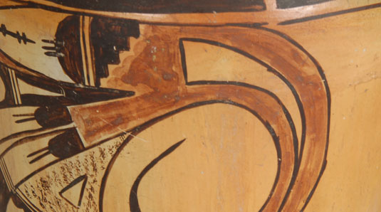The pair of black finger-nail-like elements on the bird’s wing, each of which has a pair of thin lines, have been associated with pottery by Nampeyo on many occasions and it has been stated that such design represents clouds and rain.  We see that symbol repeated on the birds tail feathers near the rim where it has three thin lines representing rain.  Stippling, as seen in the design, surrounding a small triangle, is most definitely associated with the hand of Nampeyo.