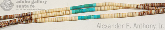 Close up view - This three-strand necklace has olive shell, melon shell and turquoise beads. Each bead was cut and rounded and then evenly strung. The three colors, brown, cream and turquoise, create a pleasing effect.