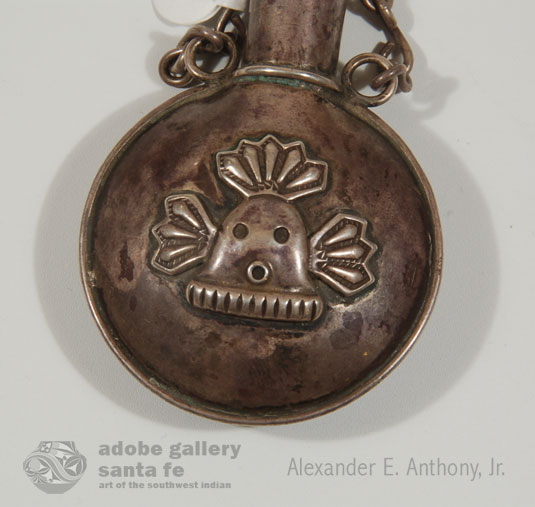 Close up view: This flask has a small Navajo Yei Mask on the front.