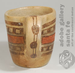 The handle has brown spots connected by parallel lines.