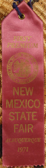 There is a ribbon attached to the basket which identifies it as “First Premium” from the New Mexico State Fair, Albuquerque, 1971.  The judge was none other than Al Packard, famous Santa Fe Indian art dealer.