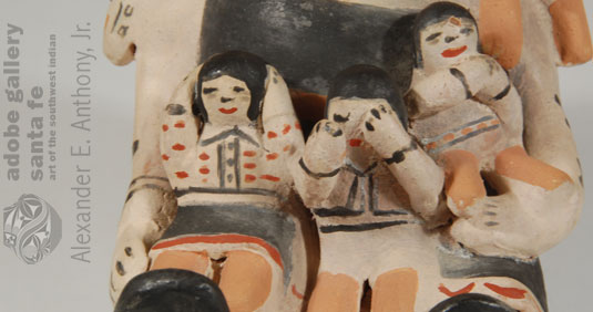 Close up view of the children attached to this Storyteller figurine.