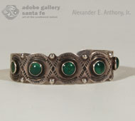 A bracelet (our Item # C4018B - click here to view) was brought to us along this pair of single-row bracelets of the same vintage and same shade of green turquoise. These two traditionally served as guards for the bracelet.