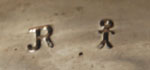 The bracelet is stamped with the artist’s initials JR and a little stickman, the hallmark of Navajo silversmith Jerry Roan. 