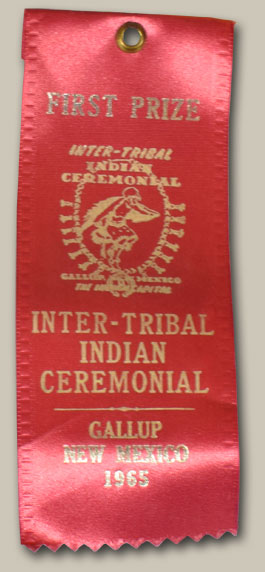 This canteen was made in 1965 and entered into the Gallup Inter-tribal Indian Ceremonial that year.  It was awarded First Prize and sold for $30.