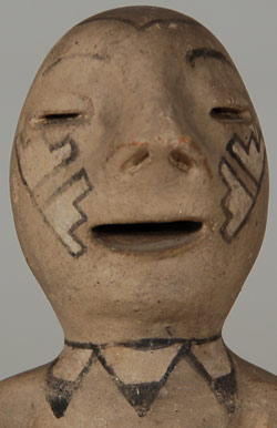 There has been much speculation regarding the origin of Tesuque Rain God figurines.  Figurative pottery from New Mexico pueblo potters has a long tradition, at least as far back as 1880 or a little earlier.  The earliest documented Rain God from Tesuque was collected in 1879.  Figurines were likewise made at Cochiti Pueblo at the same time.  There was a thriving market for such through merchants in Santa Fe who sold to visiting tourists as well as through catalogs.  Potters at Tesuque responded to requests by merchants to provide curio items for sale by the merchants to the tourist market.  While tourists were enchanted with figurative pottery and purchasing it for their own gratification, museum curators were shunning it as vulgar and low class.  Very few of the many thousands of figurines that were made ended up in museum collections at the time.  Museum curators felt that merchants were encouraging potters to make cheap kitsch at the expense of producing their traditional fine pottery.  What was poorly understood a hundred years ago is now appreciated for its uniqueness and charm.  There is some disagreement among scholars as to the actual origin of Tesuque Rain God figurines.  One scholar believes they were a revival of an older figurine pattern.  Another believes that the horns, ears, and exaggerated sexual characteristics tie them to Kokopelli, the hump-backed flute player found on rock art.  Still another scholar believes they were a rebirth of traditional figurative pottery at Cochiti and Tesuque Pueblos.  Lastly, another scholar ties the rain god to pre-Columbian funerary figures and that they were influenced by Mexican wares but interpreted from a unique pueblo perspective.  Regardless of the origin, they have existed as a pottery item from Tesuque Pueblo for at least 135 years So they are certainly traditional to the pueblo now even if not at that time.    This rain god figurine carries an unusually large pot on its lap.  There is a painted design on the head and cheeks and what can be interpreted as a necklace around the neck.  The pottery bowl is also decorated.  Condition:  very good condition with no damage and some abrasion of the painted surface expected on an item of this age. Provenance: from the collection of a former Santa Fe resident. Recommended Reading:  When Rain Gods Reigned: From Curios to Art at Tesuque Pueblo by Duane Anderson 