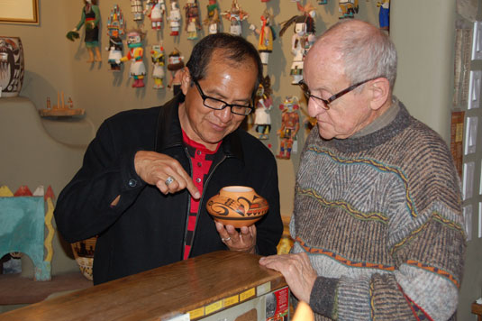 Mark Tahbo and AL Anthony looking at one of his creations at Adobe Gallery